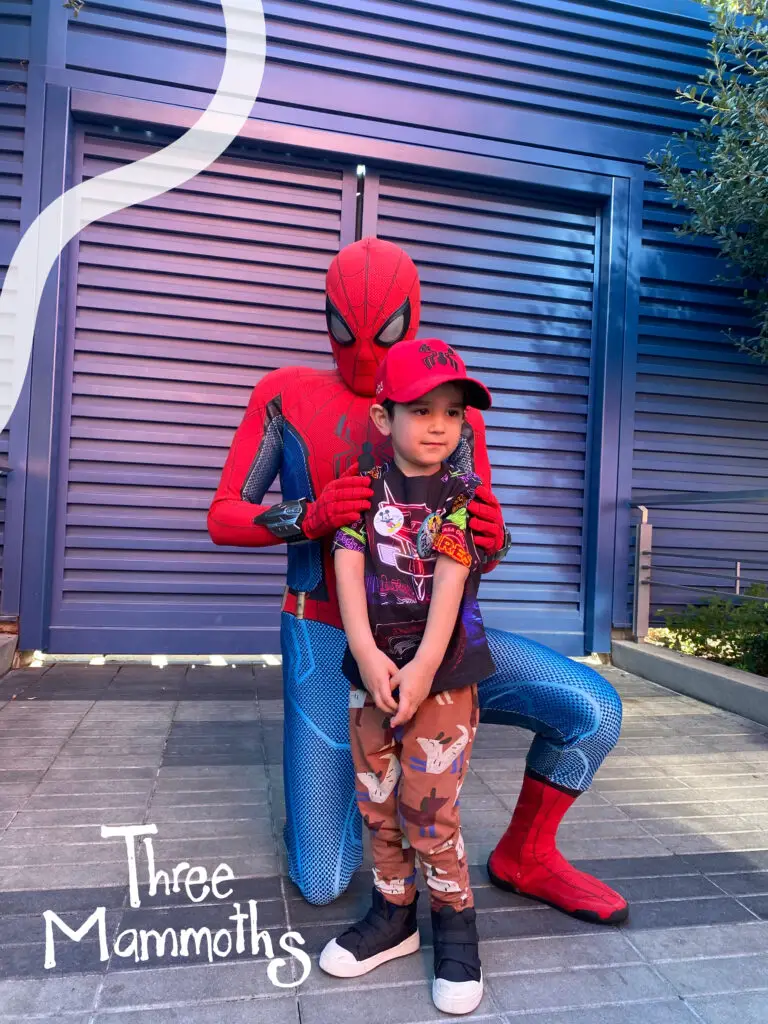 Toddler meeting Spider-Man at Disneyland, sharing an exciting moment with the iconic superhero
