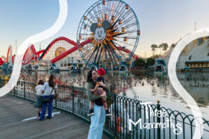 Mother and son enjoying a day at California Adventure with Mickey’s Fun Wheel in the background, creating magical memories together.