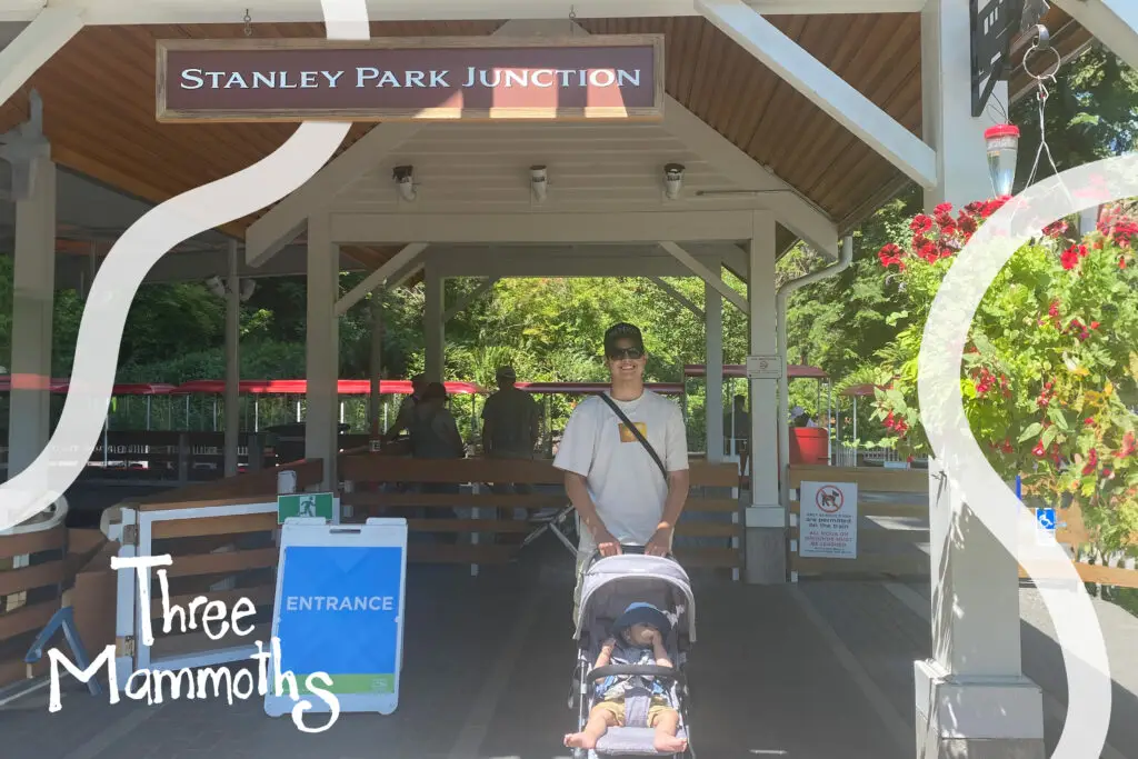 dad and toddler waiting to ride the train on stanley PARK